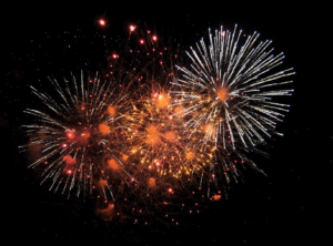 Colorful fireworks burst against a black sky, celebrating New Years Eve in Venice, Italy